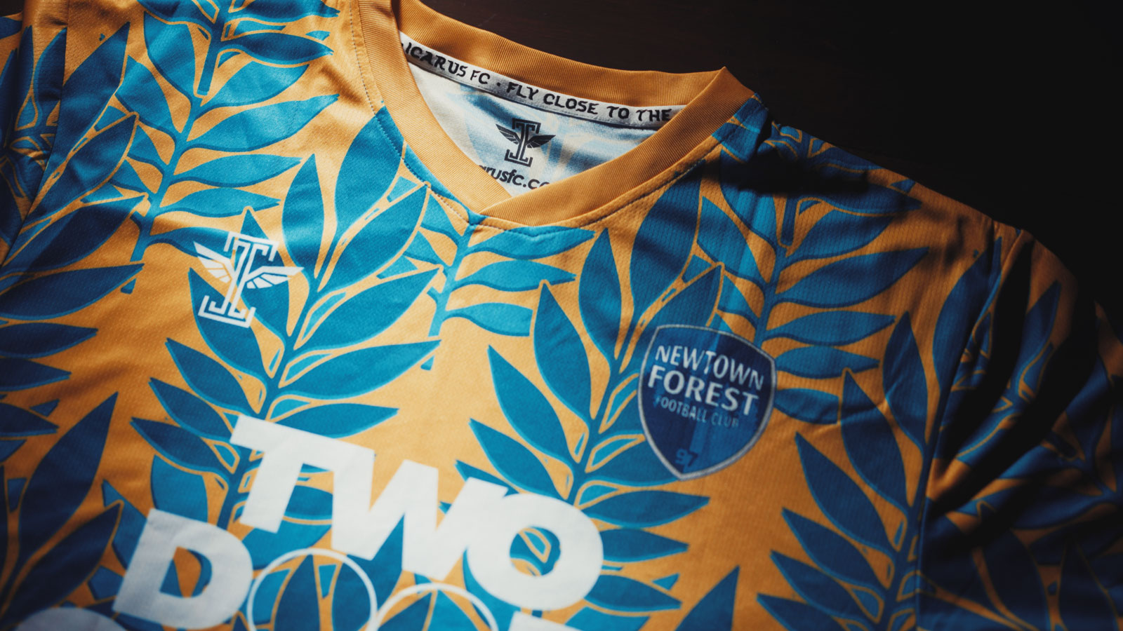 Detail of the Newtown Forest crest, the Icarus FC mark and the neck print